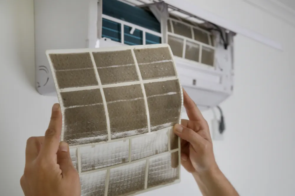 Dirty AC filter being removed during a maintenance visit in Lafayette, LA